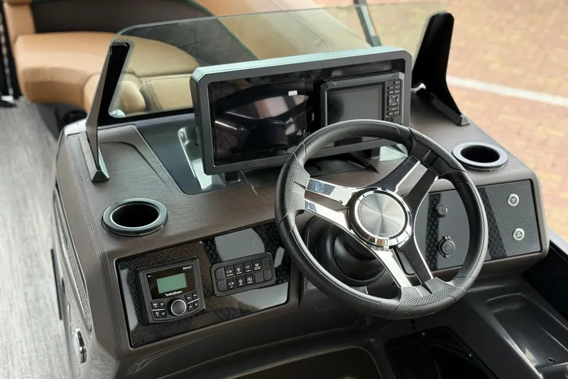Slide: The Image of 2027 Bennington 24 M Fish and Cruise dashboard with steering wheel and modern controls. - 10