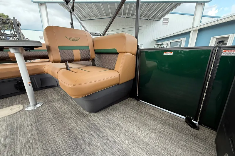Slide: The Image of 2027 Bennington 24 M Fish and Cruise interior with tan seating and green panel. - 4