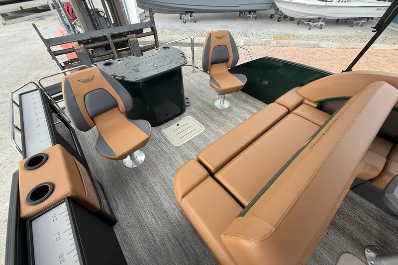 Slide: The Image of 2027 Bennington 24 M Fish and Cruise boat interior with tan seating and fishing setup. - 19