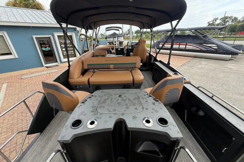 Slide: The Image of 2027 Bennington 24 M Fish and Cruise pontoon boat with tan seating and canopy. - 21