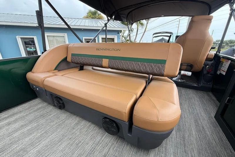 Slide: The Image of 2027 Bennington 24 M Fish and Cruise boat interior with tan seating and green accents. - 22