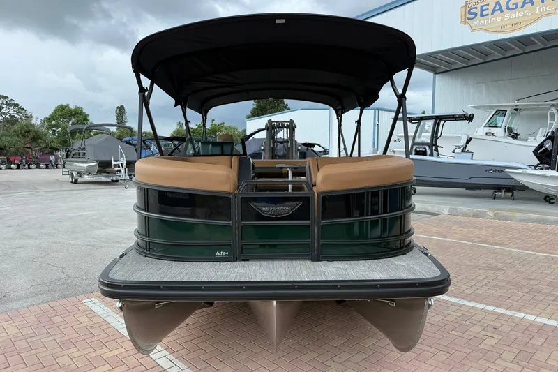 Slide: The Image of 2027 Bennington 24 M Fish and Cruise pontoon boat at a marina. - 1