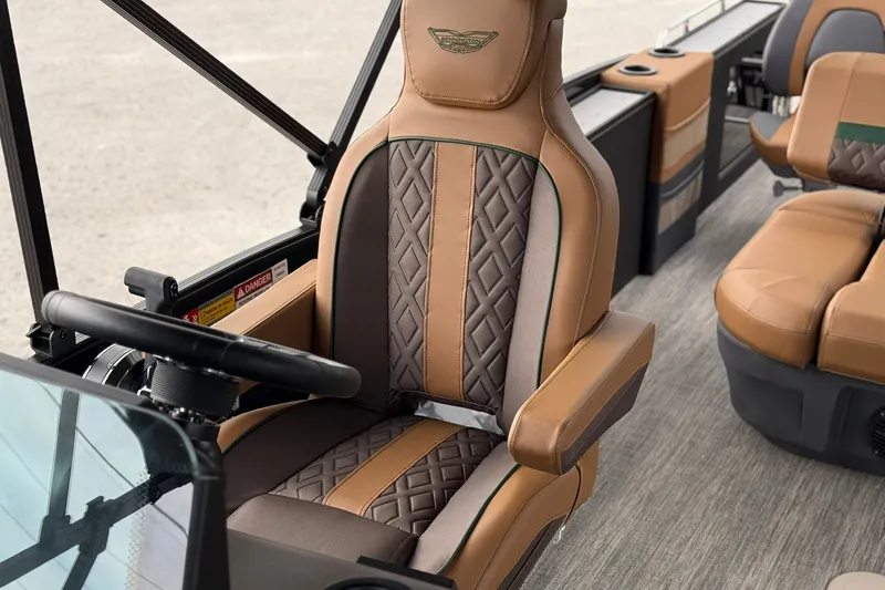 Slide: The Image of Luxurious seating in 2027 Bennington 24 M Fish and Cruise boat, featuring elegant brown upholstery. - 12