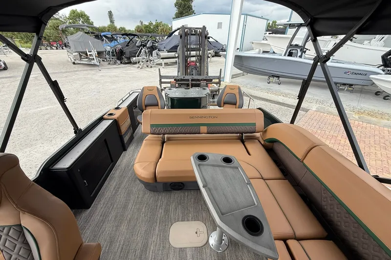 Slide: The Image of 2027 Bennington 24 M Fish and Cruise pontoon boat interior with seating and table. - 13
