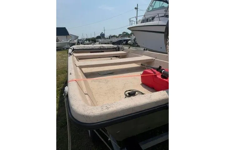 Slide: The Image of 2003 Southern Skimmer 14 Skiff boat on trailer, parked outdoors. - 9