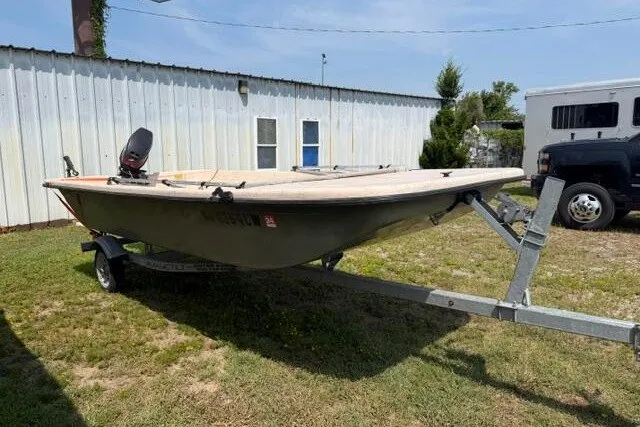 Slide: The Image of 2003 Southern Skimmer 14 SKIFF boat on trailer, parked outdoors near a building. - 3