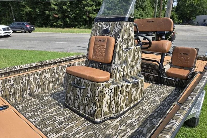 Slide: The Image of 2027 Avid 20 Rogue CC boat with camouflage design and brown seating. - 6