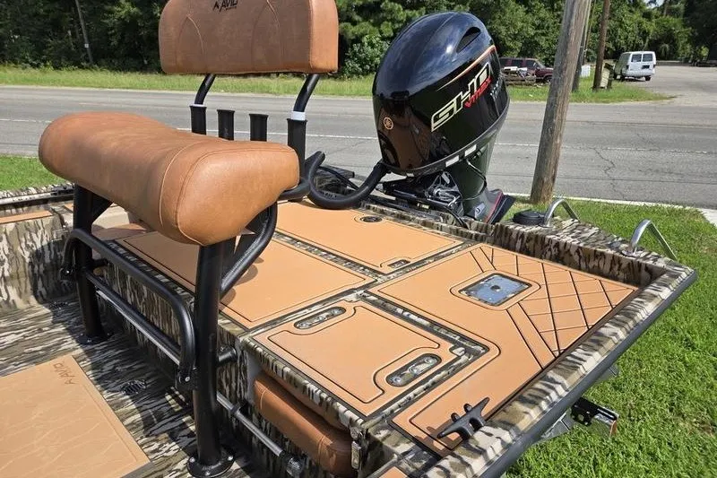 Slide: The Image of Avid 20 Rogue CC 2027 boat with tan seating and powerful outboard motor. - 11