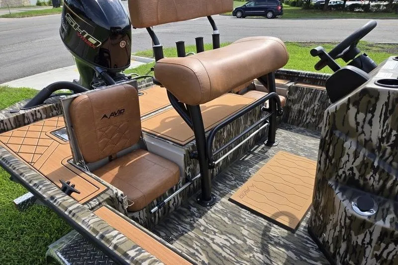 Slide: The Image of 2027 Avid 20 Rogue CC boat interior with camo design and tan seating. - 5