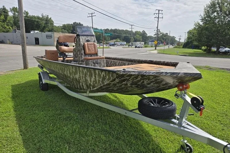 Slide: The Image of 2027 Avid 20 Rogue CC boat on trailer, parked on grass near road. - 8