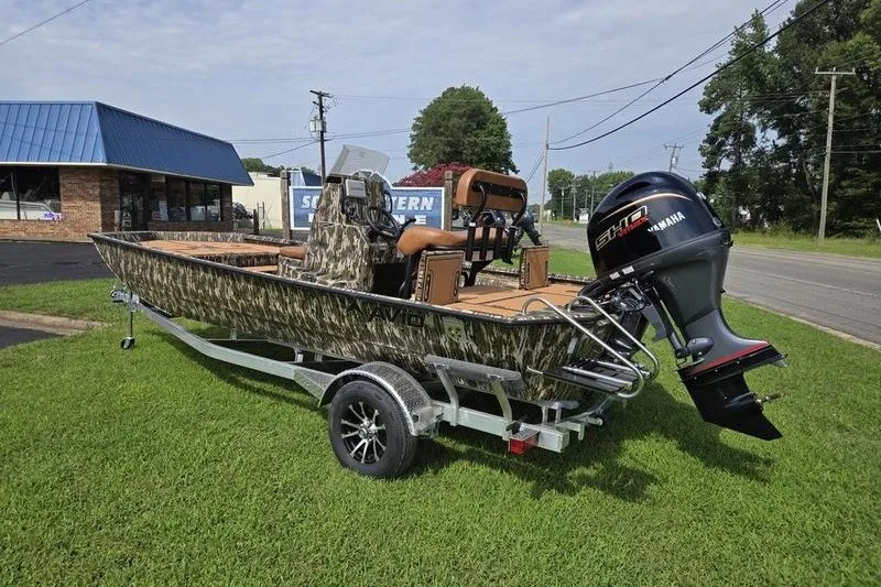 Slide: The Image of 2027 Avid 20 Rogue CC boat on trailer with Yamaha motor, parked on grass. - 4