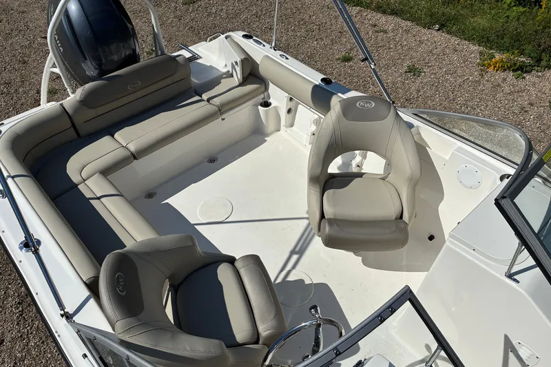 Slide: The Image of 2023 Key West 203 DFS boat interior with beige seating and steering wheel. - 15