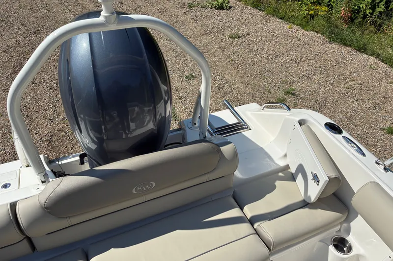 Slide: The Image of 2023 Key West 203 DFS boat interior with seating and engine view. - 16
