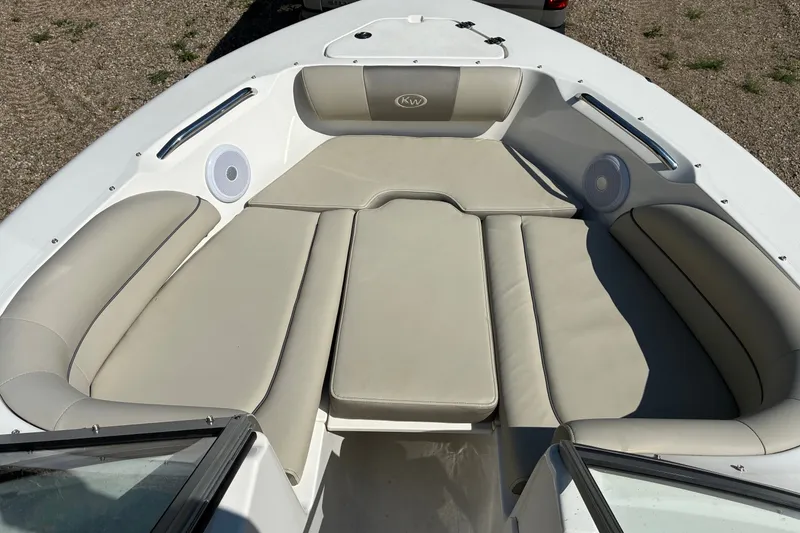 Slide: The Image of 2023 Key West 203 DFS boat interior with beige seating and built-in speakers. - 14