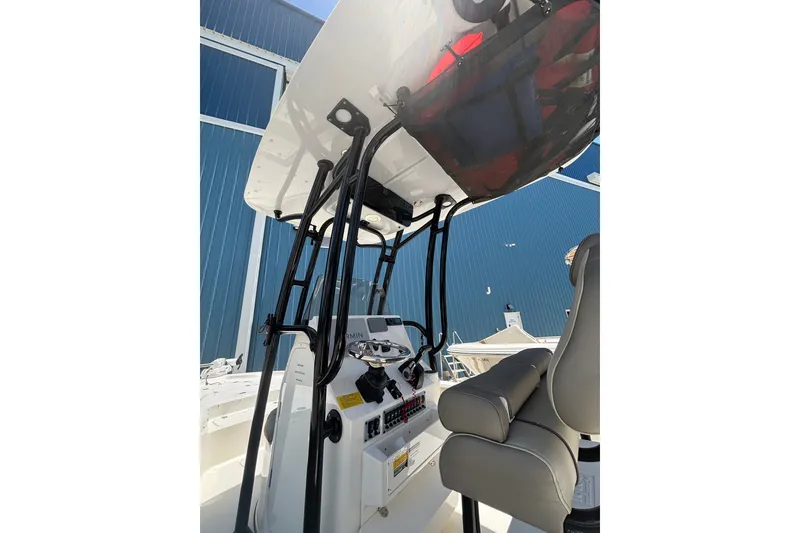 Slide: The Image of 2023 Key West 239 FS boat interior with steering console and seating. - 6