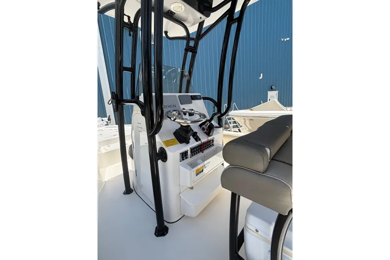 Slide: The Image of 2023 Key West 239 FS boat interior with steering console and seating. - 5