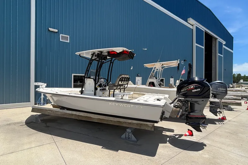 Slide: The Image of 2023 Key West 239 FS boat with Yamaha engine outside a blue warehouse. - 3