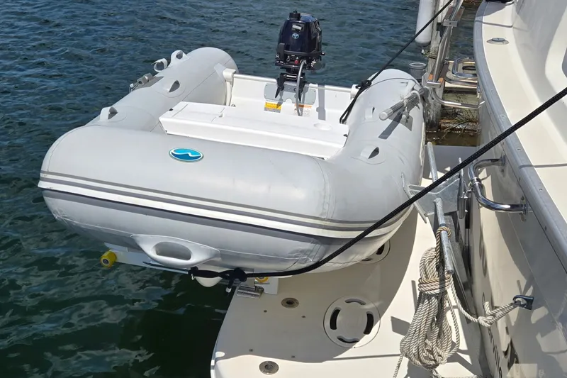 Slide: The Image of Inflatable dinghy attached to a 1988 Mainship 36 Double Cabin yacht on water. - 13