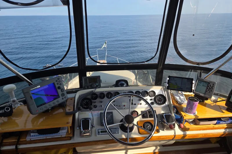 Slide: The Image of Cockpit view of 1988 Mainship 36 Double Cabin with navigation equipment and ocean horizon. - 5