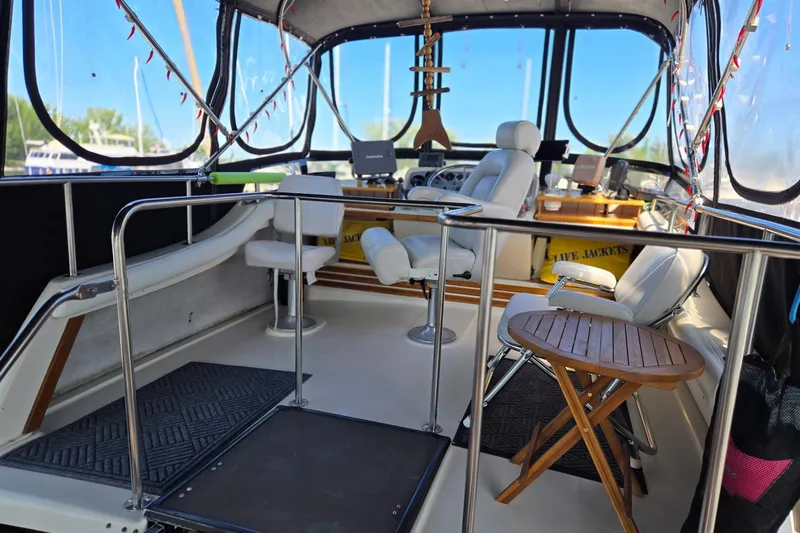 Slide: The Image of 1988 Mainship 36 Double Cabin interior with helm, seating, and wooden table. - 4