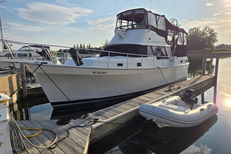 Slide: The Image of 1988 Mainship 36 Double Cabin yacht docked with inflatable boat nearby. - 2