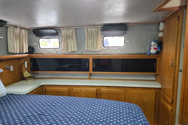 Slide: The Image of Cozy cabin interior of 1988 Mainship 36 Double Cabin with wooden cabinetry and nautical decor. - 10