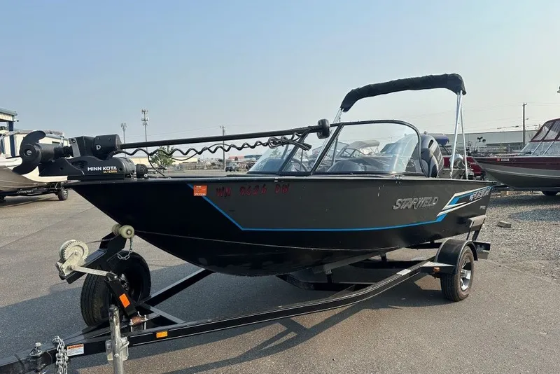 The Image of 2021 Starweld Fusion 16 DC boat on trailer, featuring Minn Kota motor. - 0