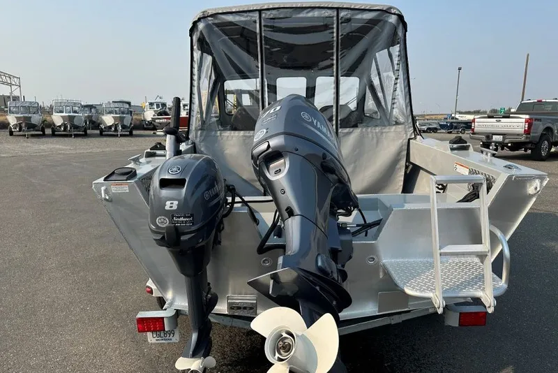 Slide: The Image of 2018 Hewescraft 160 Sportsman boat with dual Yamaha outboard motors, parked in a marina. - 2