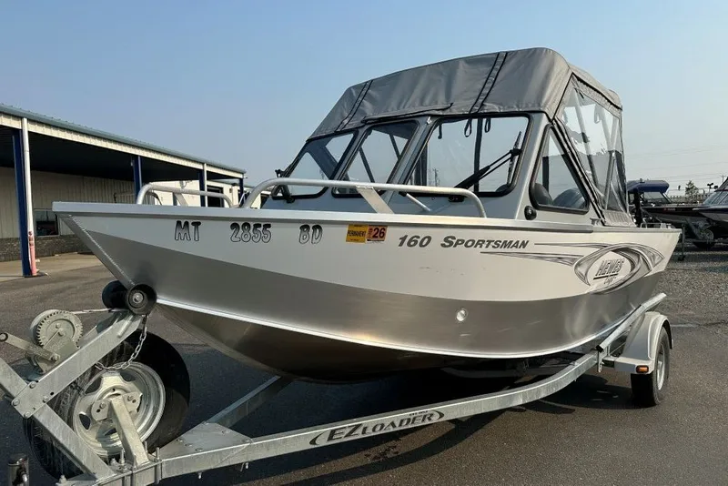 The Image of 2018 Hewescraft 160 Sportsman boat on trailer, parked outdoors. - 0