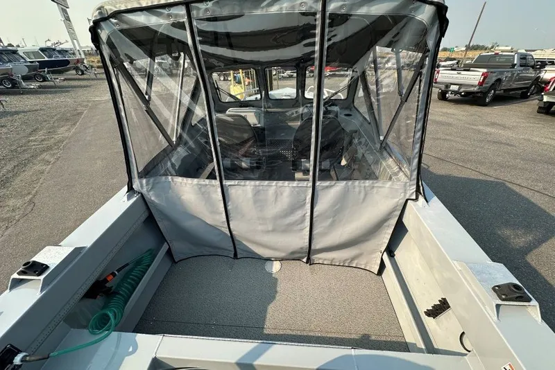 Slide: The Image of 2018 Hewescraft 160 Sportsman boat with canopy, parked in a lot. - 3
