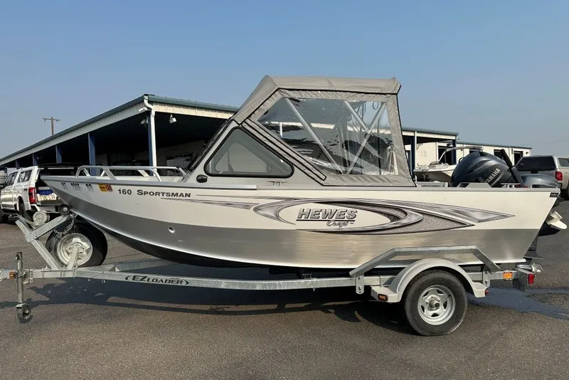 Slide: The Image of 2018 Hewescraft 160 Sportsman boat on trailer, parked outdoors. - 1