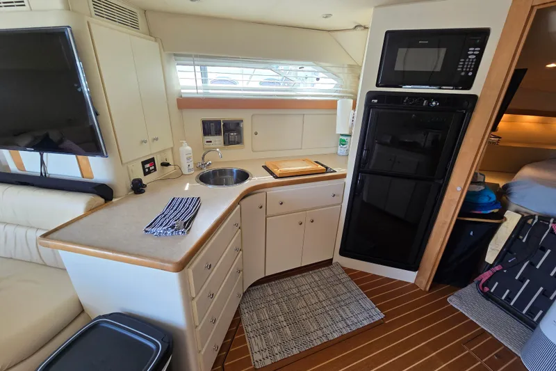 Slide: The Image of Interior of 1996 Carver 380 Santego yacht kitchen with appliances and cabinetry. - 16
