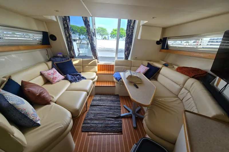 Slide: The Image of Luxurious interior of a 1996 Carver 380 Santego yacht with plush seating and elegant decor. - 14