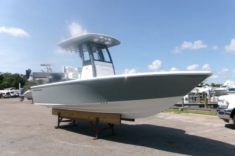 The Image of 2027 Sportsman Masters 227 Bay Boat displayed on a stand in a marina. - 1