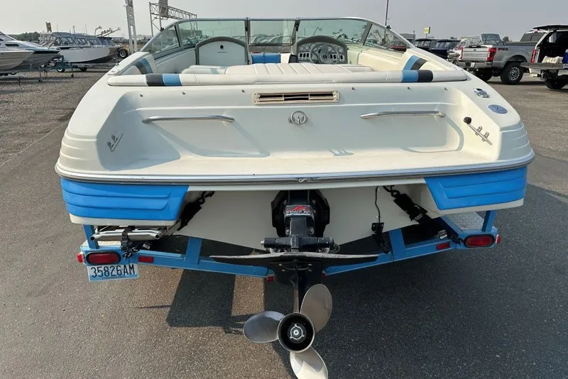 Slide: The Image of 1994 Reinell 184 boat, rear view, on trailer, showcasing propeller and seating area. - 3