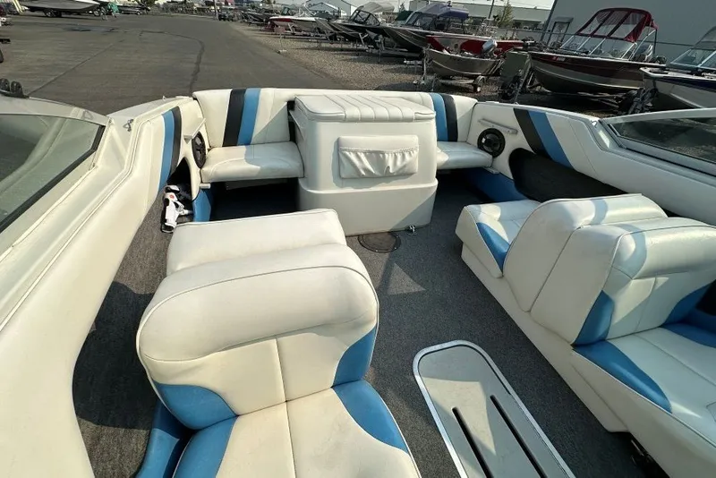 Slide: The Image of Interior of a 1994 Reinell 184 boat with white and blue seating. - 5