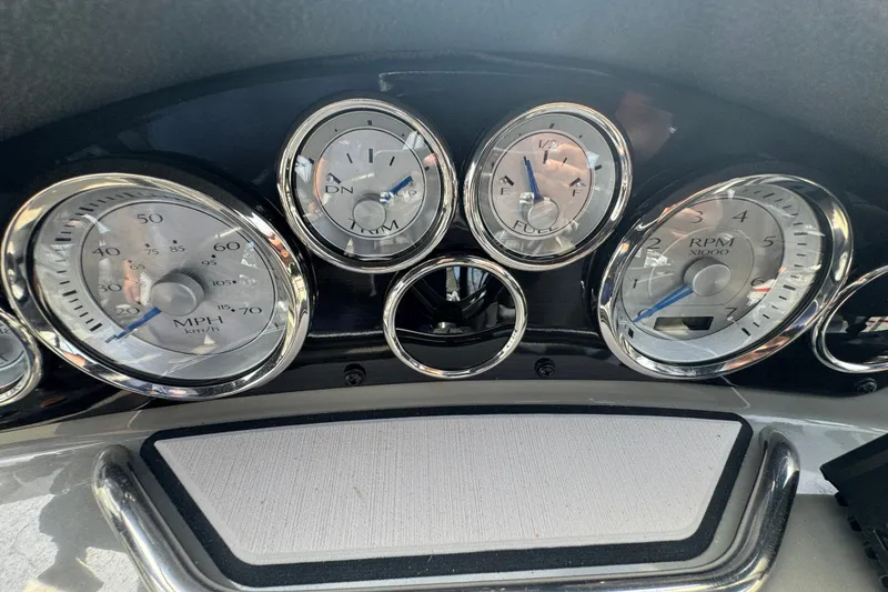 Slide: The Image of Dashboard of a 2022 Stingray 214 LR boat with chrome-trimmed gauges. - 12