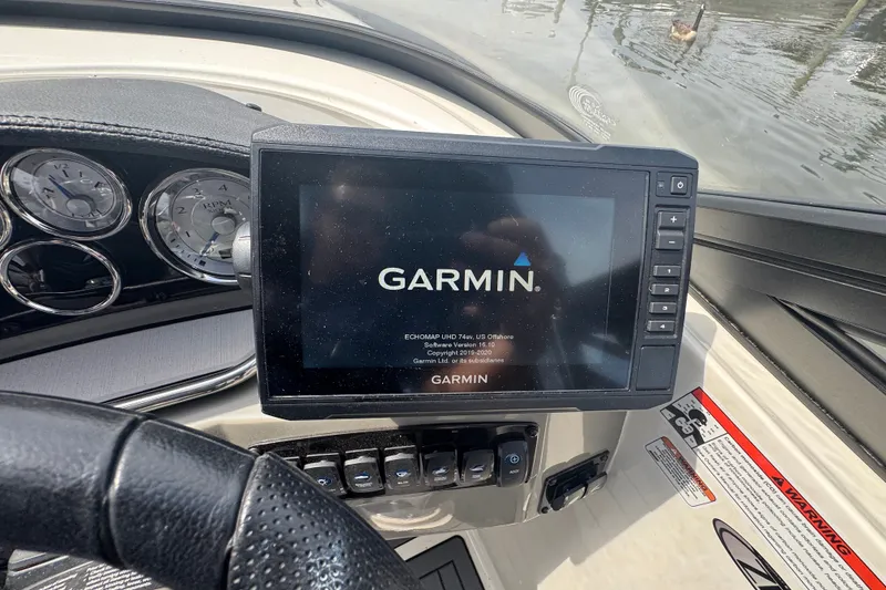 Slide: The Image of Garmin display on 2022 Stingray 214 LR boat dashboard with gauges and controls. - 10