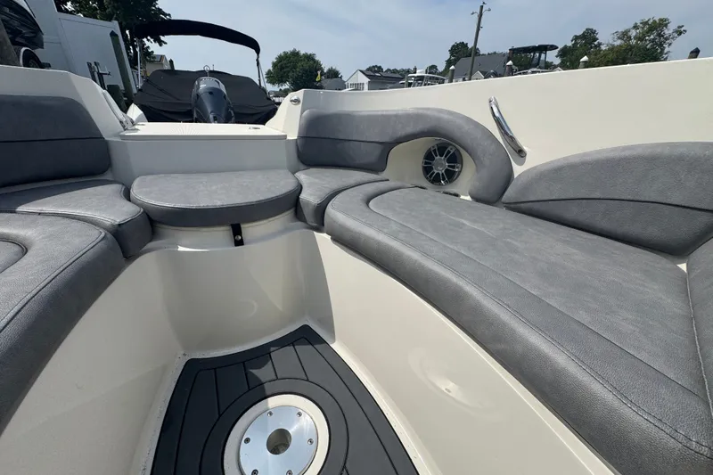 Slide: The Image of 2022 Stingray 214 LR boat interior with gray seating and modern design. - 20
