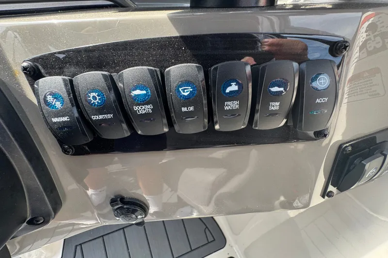 Slide: The Image of Control panel of a 2022 Stingray 214 LR boat with labeled switches. - 11
