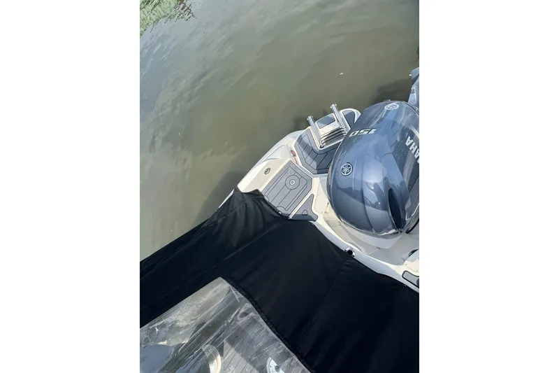 Slide: The Image of A 2022 Stingray 214 LR boat with a Yamaha outboard motor on calm water. - 5