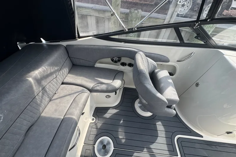 Slide: The Image of 2022 Stingray 214 LR boat interior with gray seating and sleek design. - 14
