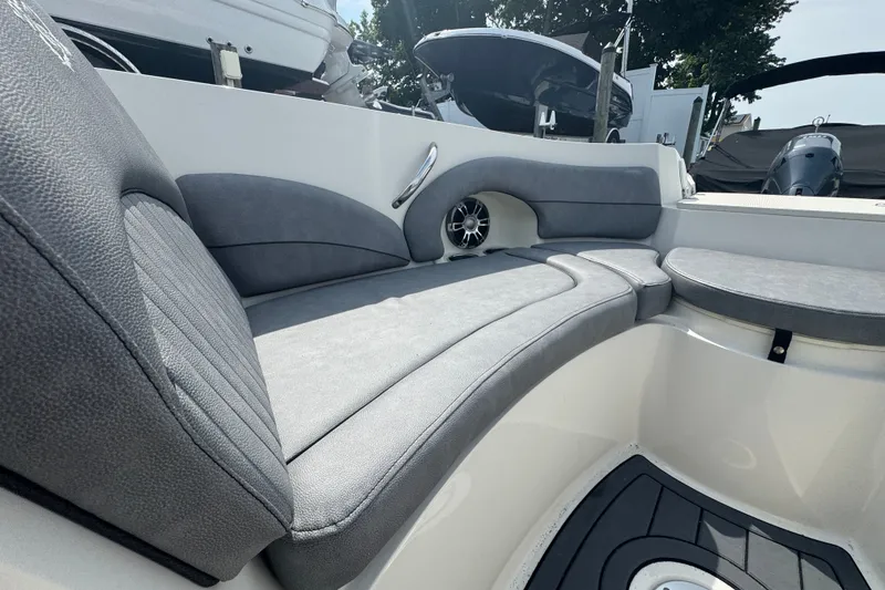 Slide: The Image of 2022 Stingray 214 LR boat interior with gray seating and speaker detail. - 19