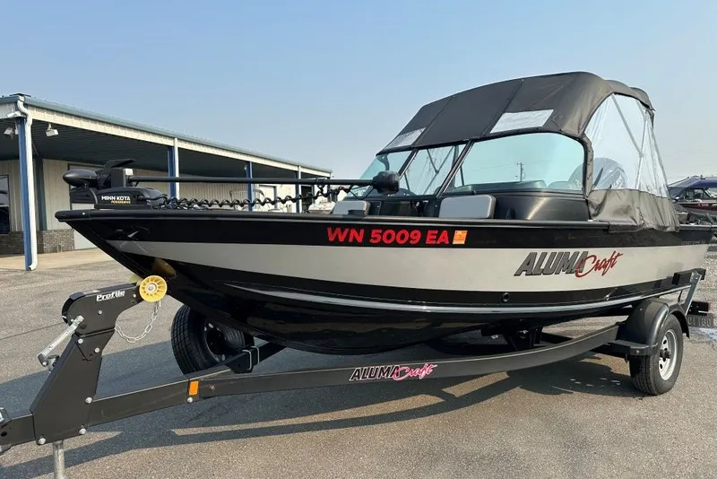The Image of 2023 Alumacraft Competitor FSX 175 boat on trailer, parked outdoors. - 0