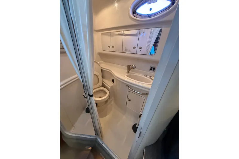 Slide: The Image of Compact bathroom in 2007 Sea Ray 340 Sundancer yacht, featuring toilet, sink, and mirror. - 18