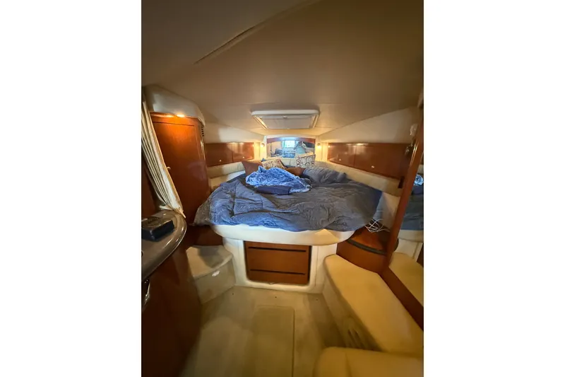 Slide: The Image of Interior cabin of 2007 Sea Ray 340 Sundancer with cozy bedding and wooden accents. - 17