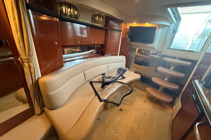 Slide: The Image of Interior of 2007 Sea Ray 340 Sundancer yacht with plush seating and wooden cabinetry. - 14