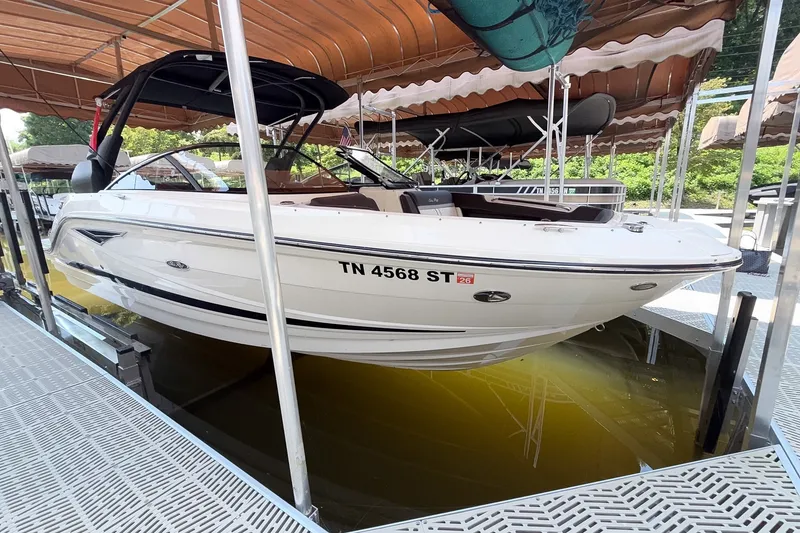 The Image of 2017 Sea Ray SLX 250 boat docked, featuring sleek white design and modern amenities. - 1