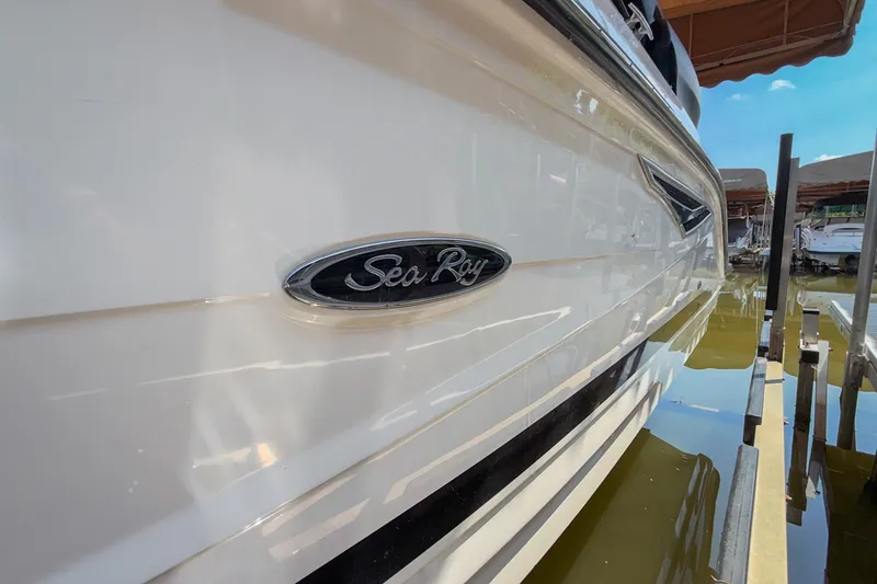 Slide: The Image of 2017 Sea Ray SLX 250 boat docked, showcasing sleek white exterior and logo. - 17