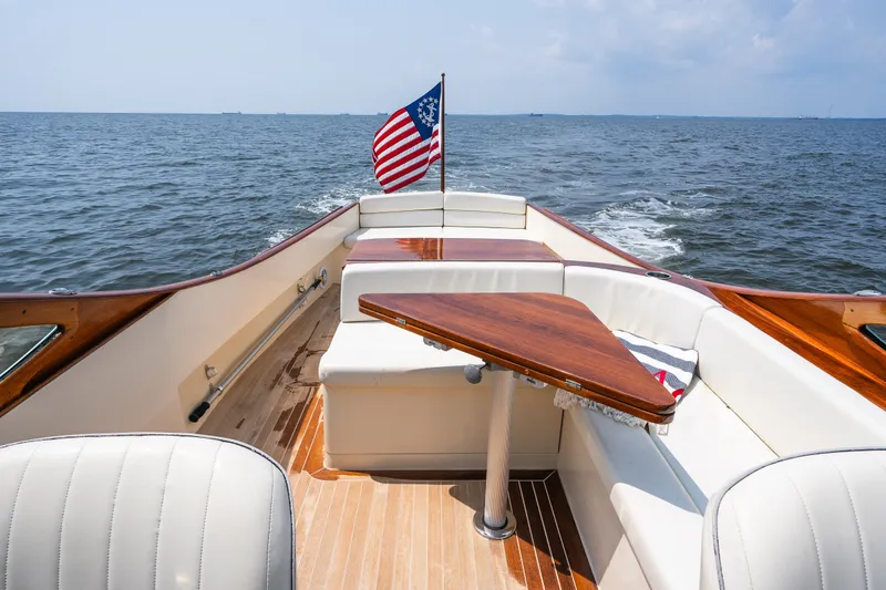 Slide: The Image of 2008 Hinckley Talaria 29R boat interior with American flag, cruising on open water. - 38